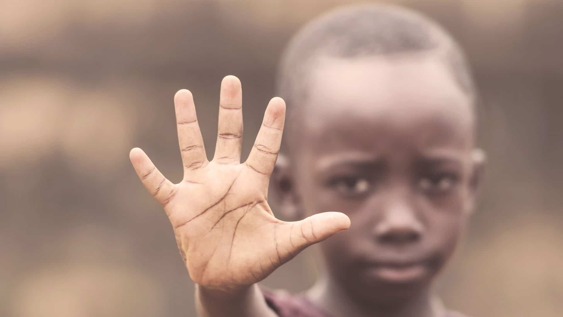 african child holding hand up