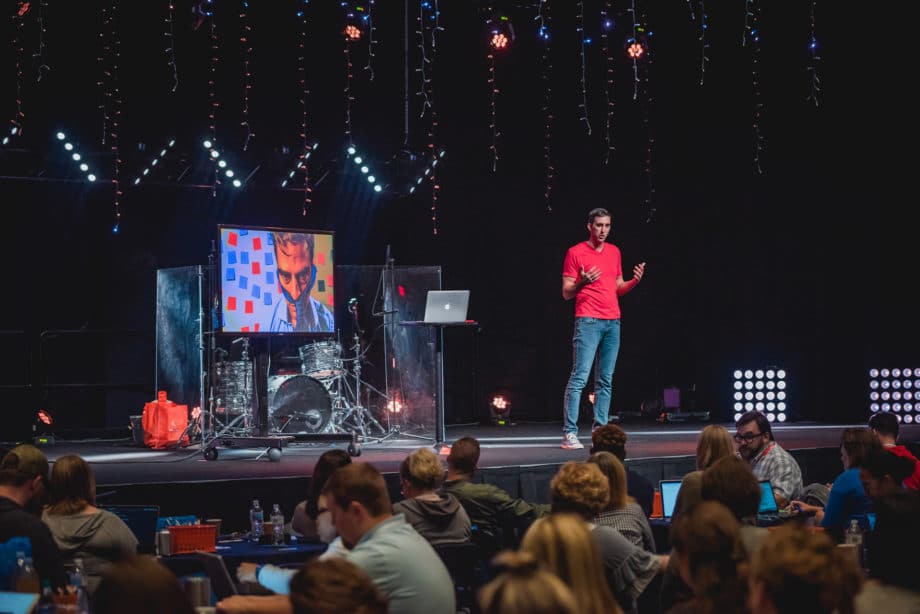dustin stout speaking on stage at massive conference