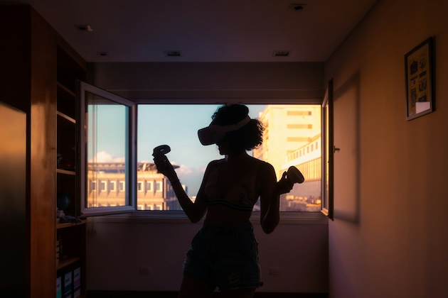 girl playing vr gaming at sunset