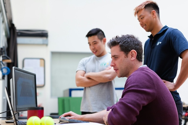 man in maroon long sleeve shirt holding a book - Sports engineers monitor tennis footage