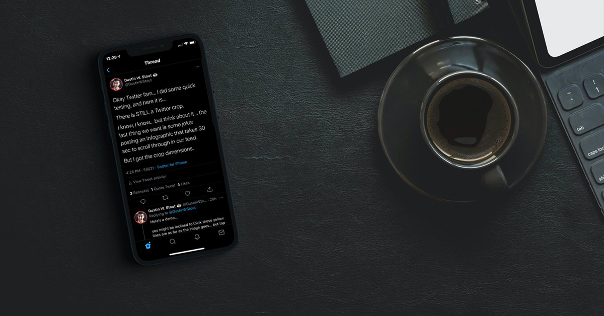 iphone with twitter image on dark desk