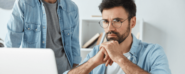 businessmen-sit-office-desk-together-work-communicate-concentrated-into-laptop-computer