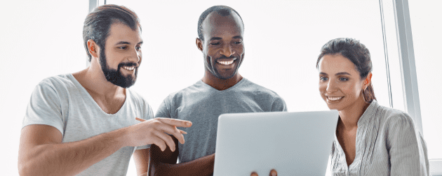 three-smiling-business-colleagues-standing-modern-office-interior-looking-screen