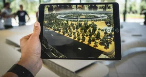 ar: person holding black iPad simulating occupied space over architectural model