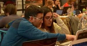 Cloud Migration: a group of people sitting at a table with laptops discuss their options