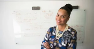 customer centric product: woman in blue and gray long-sleeved shirt wearing gold-colored necklace