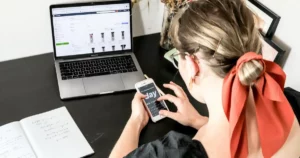 ecommerce platform: digital marketing, woman in orange shirt using iphone