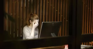 job dissatisfaction: a woman sitting in front of a laptop computer looking anxious, burnout, stressed, and stressed out