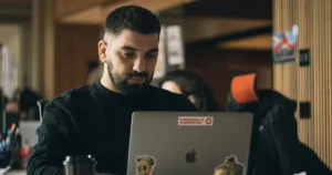 Leading Remote Teams: man in black crew neck shirt using macbook