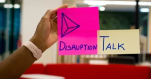 strategic disruption: person holding pink sticky notes