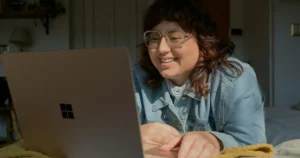 tech interview questions: a-woman-in-glasses-is-looking-at-a-laptop