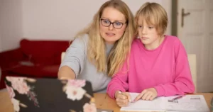 Mother and daugther learning together via laptop. Parents are becoming more actively involved in their children's education, collaborating with AI-powered platforms to track progress, receive personalized recommendations, and provide additional support at home.